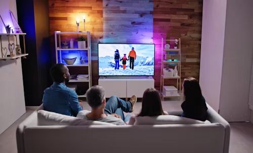 Family watching live TV in the living room